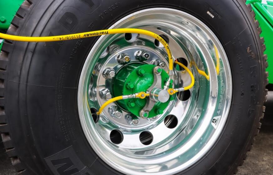 Technician performing CTIS pressure testing on heavy duty truck tires using central tire inflation system