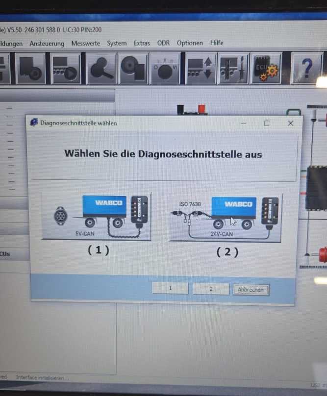 Technician checking WABCO diagnostic cable and vehicle power connection